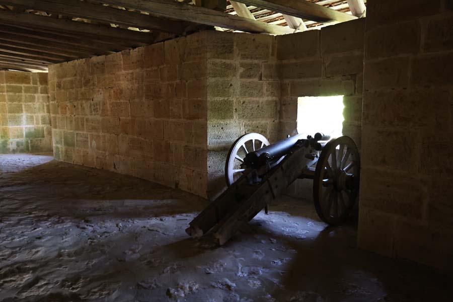 Cannon in the window in a stone hall